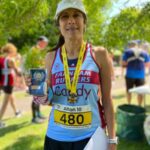Candy Waller of Farnham Runners with her medal, trophy and prize after the 2025 Alton10 race