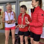 On the podium, Linda Tyler (centre) 1st 65 at the 2025 Abingdon Marathon