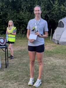Lizzie May with her 3rd lady prize at the 2025 Gibbet Hill 10k