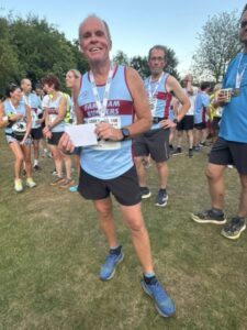 Justin Clarke with his 1st M65 prize at the 2025 Gibbet Hill 10k