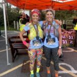 Gemma Whitehouse (left) and Georgie Abrook (right) with their 2025 Gower 23 mile trail race finishers medals