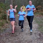 Left to tight Lizzie Collins, Colette Grist and Jess Lira running in the 2026 SXCL race in the Bourne Woods in Farnham