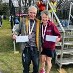Farnham Runners Andy Papworth and Linda Tyler with their prizes after the 2026 Fleet Half Marathon
