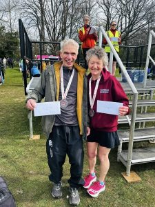 Farnham Runners Andy Papworth and Linda Tyler with their prizes after the 2026 Fleet Half Marathon