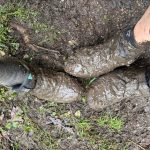 Closeup of muddy running shoes after the 2026 Grizzly race