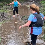 Runners running through a stream at the 2026 Grizzly race