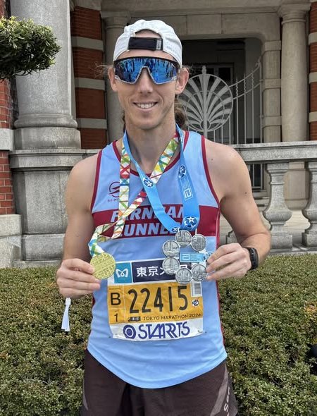 Chris Matthews with his Tokyo Marathon and Six Star medals